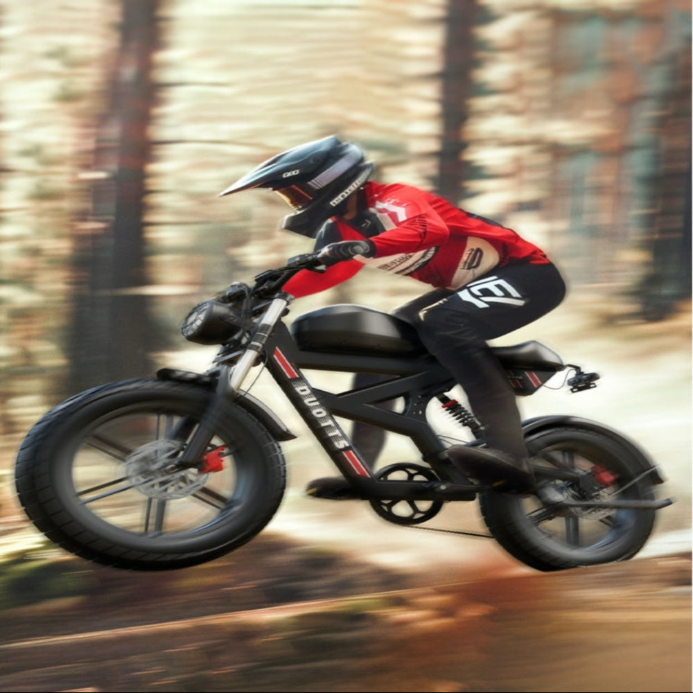 Person riding a motorcycle on a forest path