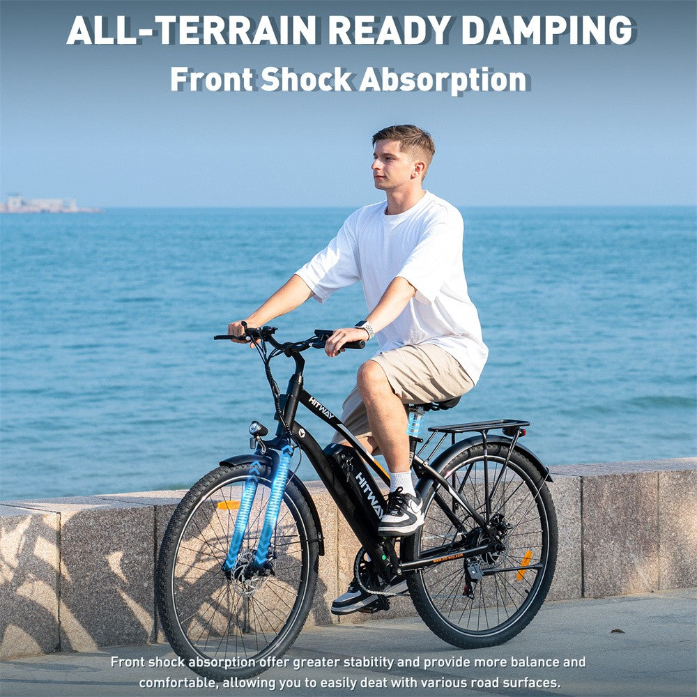 Person riding an electric bike by the sea with text about all-terrain ready damping and front shock absorption.