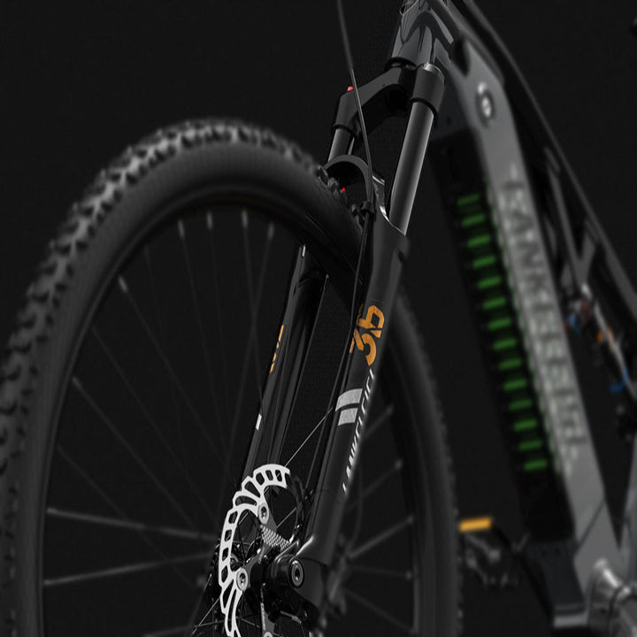 Close-up of a bicycle's front wheel and suspension fork on a dark background
