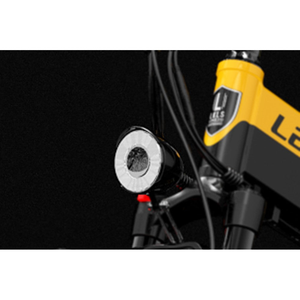 Close-up of a bicycle headlight with a black background