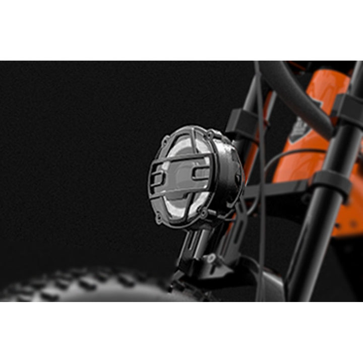 Close-up of a motorcycle light with a brand logo on a black background