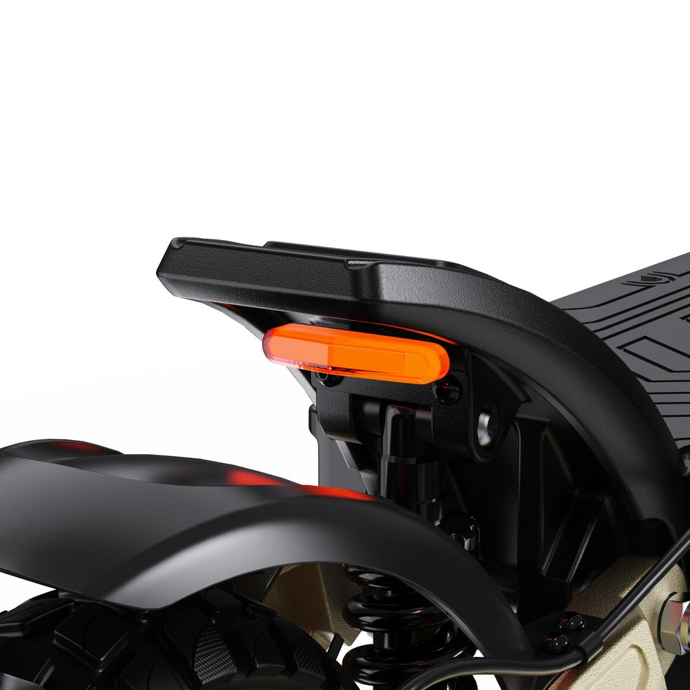 Close-up of a motorcycle's rear fender with an orange reflector on a white background