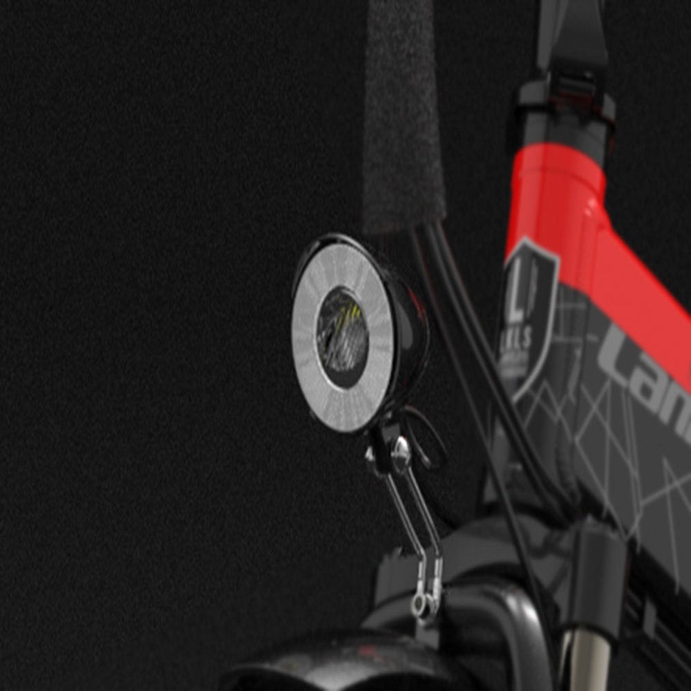 Close-up of a bicycle handlebar with a gauge and brand logo against a dark background
