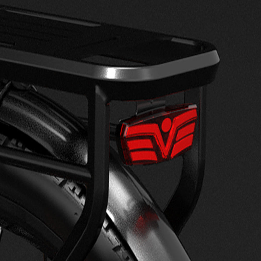 Close-up of a black vehicle bumper with a red logo on a dark background