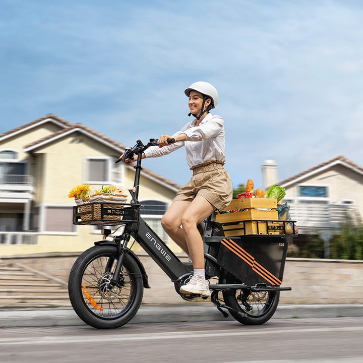 Person riding an electric bike with cargo boxes on a residential street