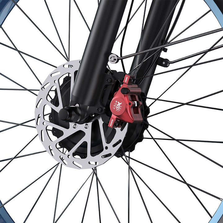 Close-up of a bicycle wheel with a red brake caliper and disc rotor.