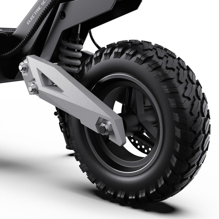Close-up of a black off-road tire with tread pattern on a white background
