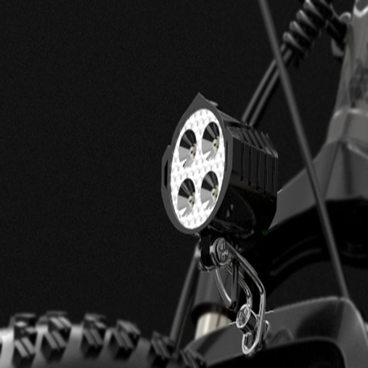 LED work light attached to a vehicle's roof rack on a dark background