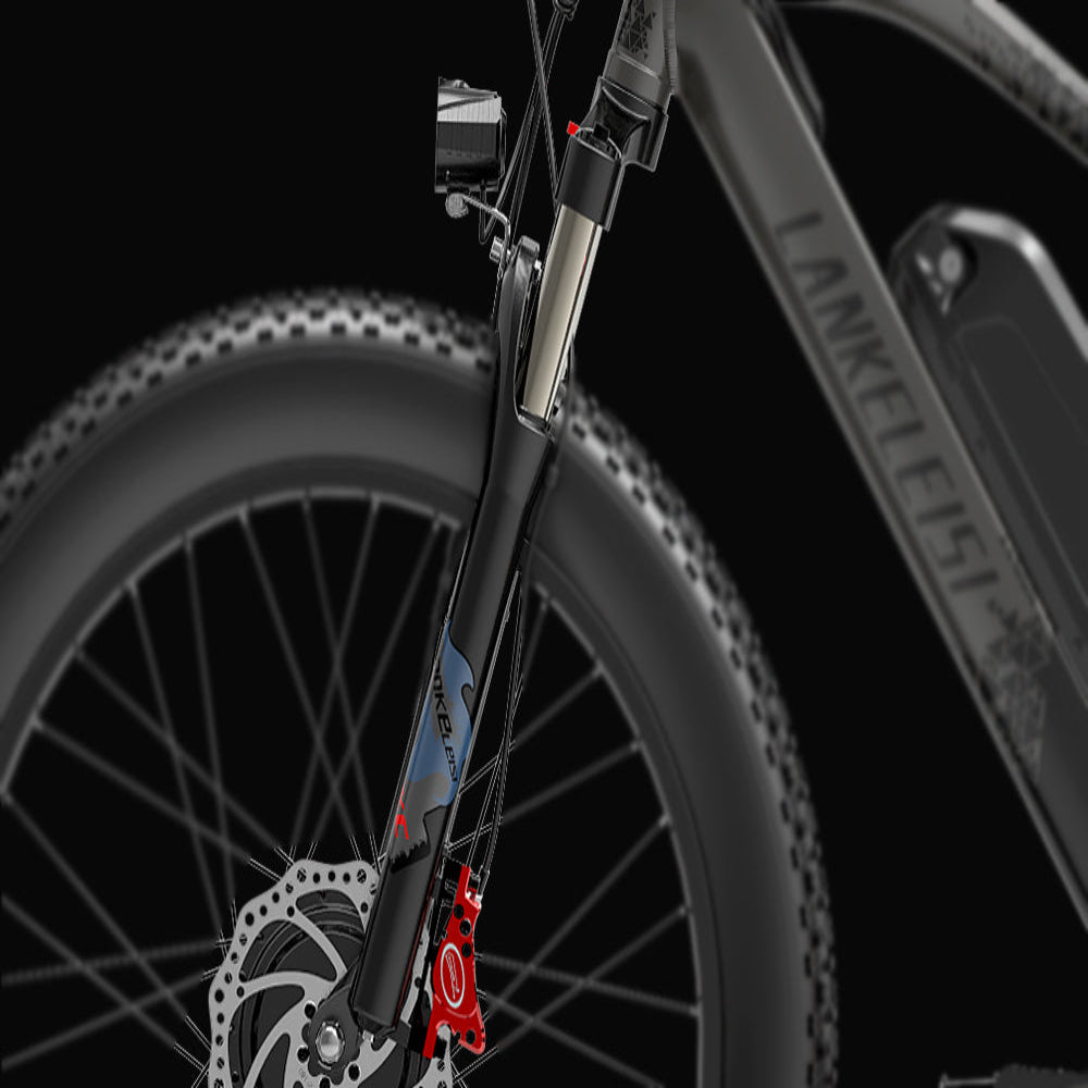 Close-up of a bicycle's front wheel and suspension fork on a black background