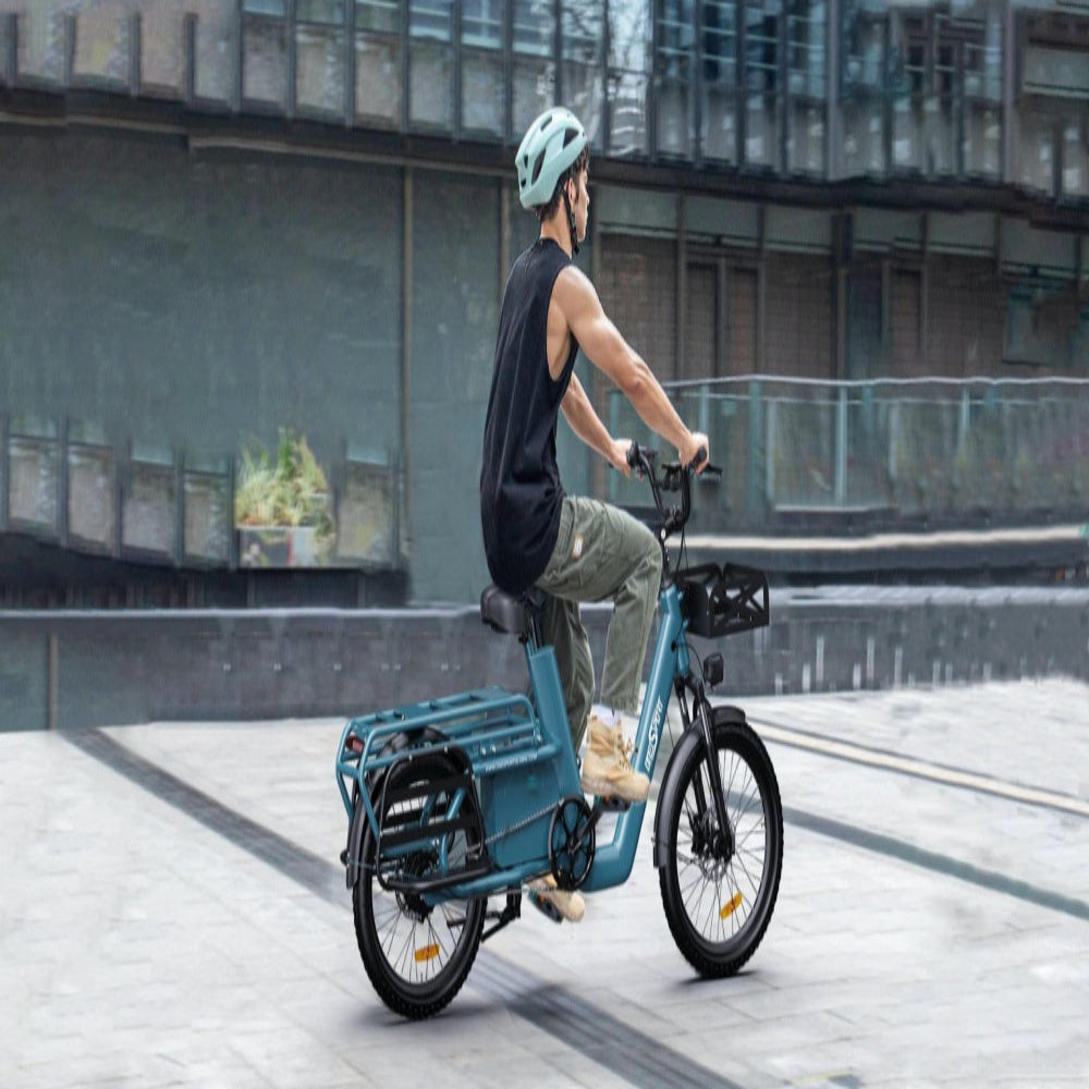 Person riding a blue electric bike in an urban setting.