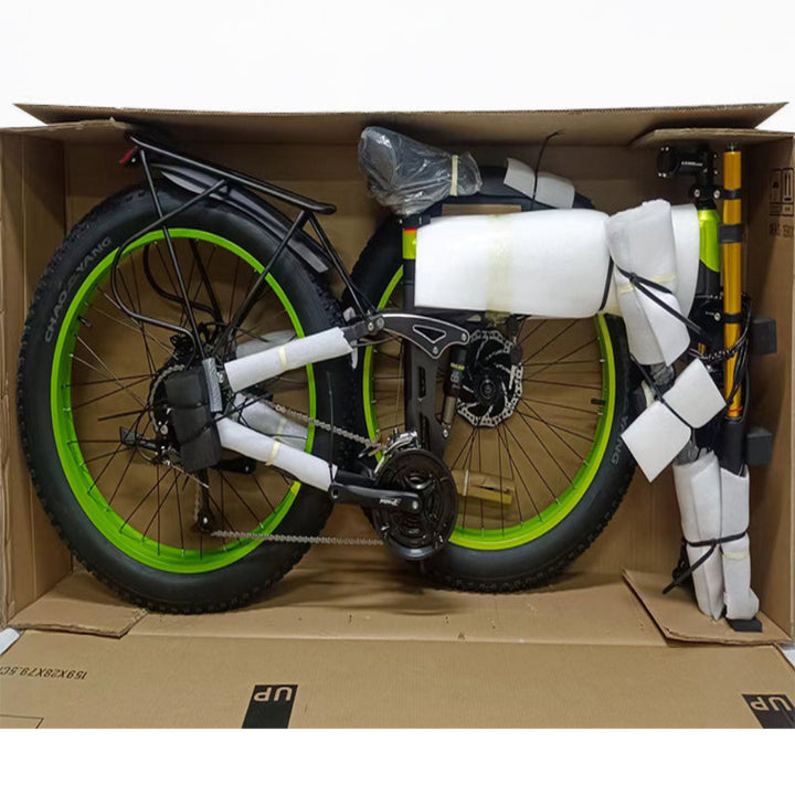 e-bike with green wheels inside a cardboard box