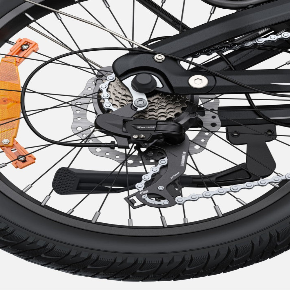 Close-up of a bicycle wheel with gear and chain mechanism on a white background