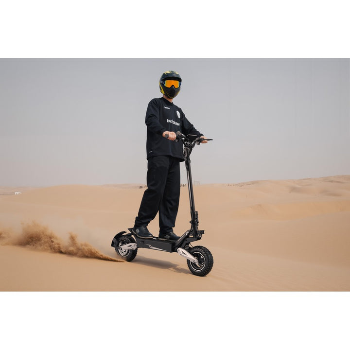 Person riding an electric scooter in a desert setting