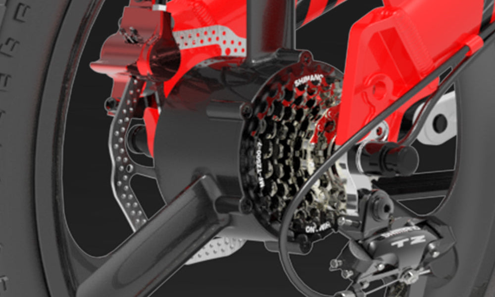Close-up of a motorcycle's wheel and suspension system with a focus on the red suspension components.