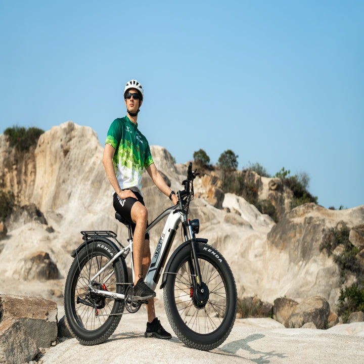 Person with an electric bike in a rocky outdoor setting