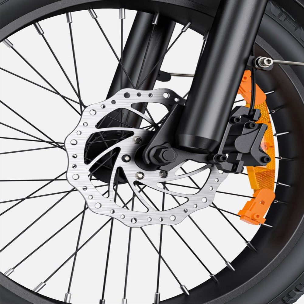 Close-up of a motorcycle wheel with disc brake system on a white background
