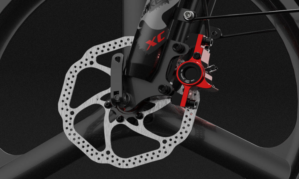 Bicycle disc brake system with red and black components on a dark background