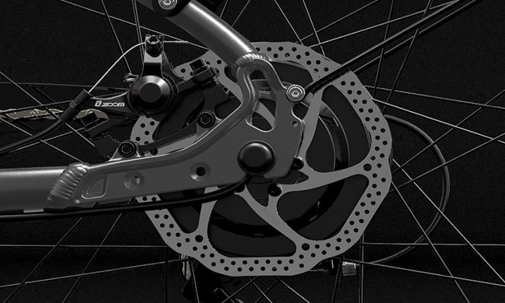 Close-up of a bicycle disc brake system with a dark background