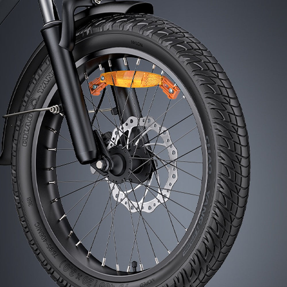 Close-up of a bicycle wheel with disc brake system on a gray background