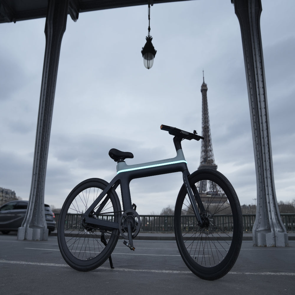 Modern bicycle in front of the Eiffel Tower on a cloudy day