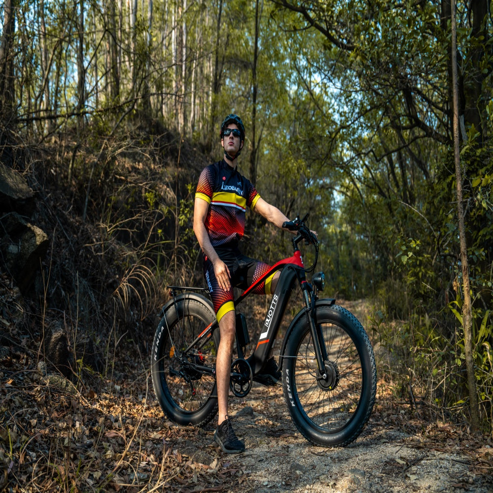 Man with a mountain bike in a forest setting