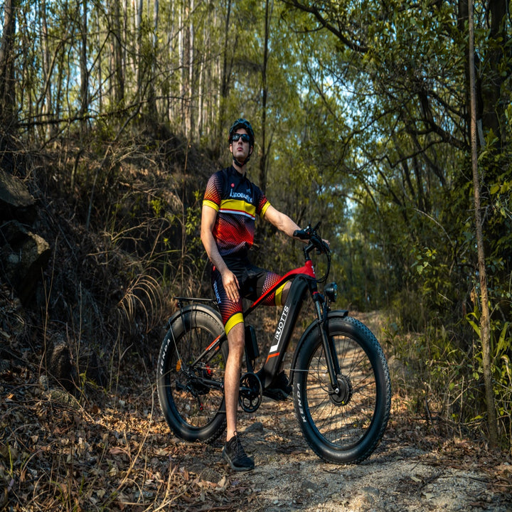Man with a mountain bike in a forest setting
