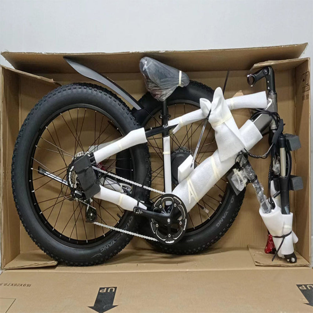 Bicycle inside a cardboard box on a plain background