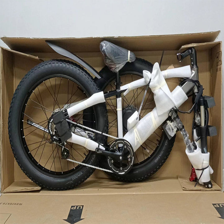 Bicycle inside a cardboard box on a plain background