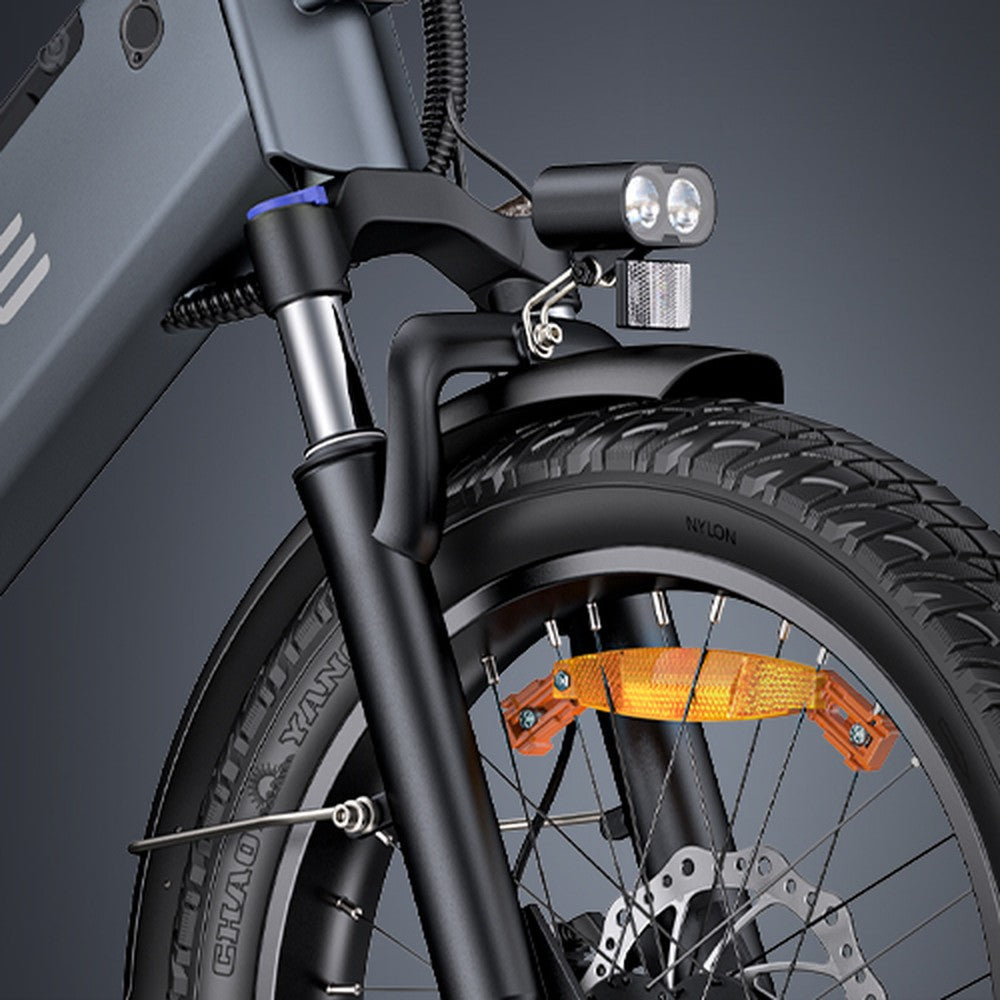 Close-up of a bicycle's front wheel and suspension fork with a dark background