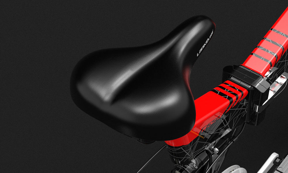 Close-up of a black bicycle seat on a red frame against a dark background