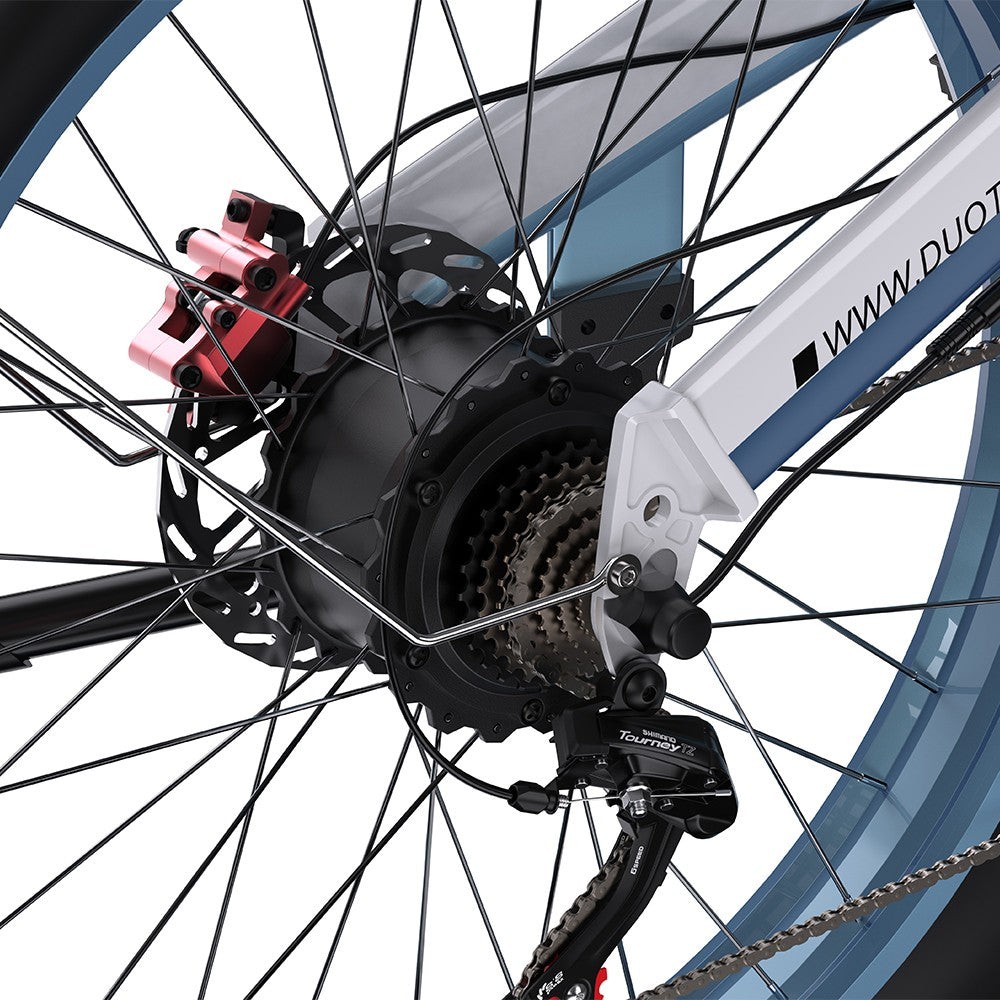 Close-up of a bicycle wheel with gear and chain mechanism on a white background