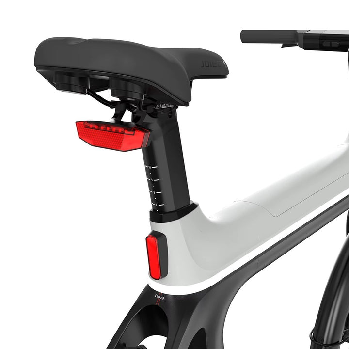 Close-up of a bicycle seat with red reflectors on a white background