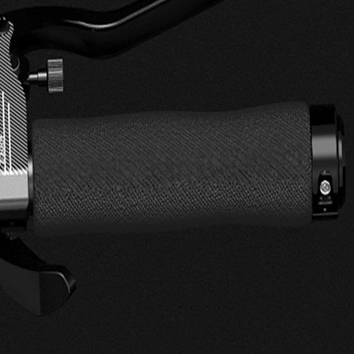 Close-up of a black motorcycle handlebar grip on a dark background