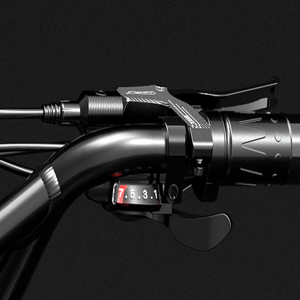 Close-up of a motorcycle handlebar with a digital display on a black background